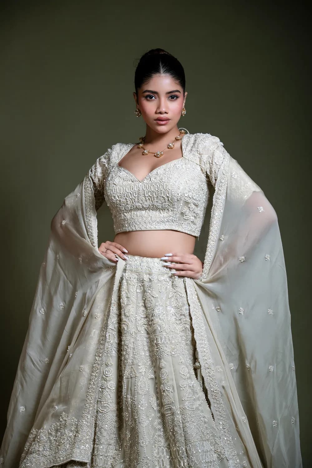 Model wearing the Rudrayani Light Ivory Embroidered Lehenga Set with Dupatta